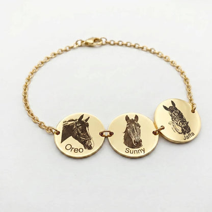 Gold bracelet with three round pendants featuring horse portraits and names on a white background