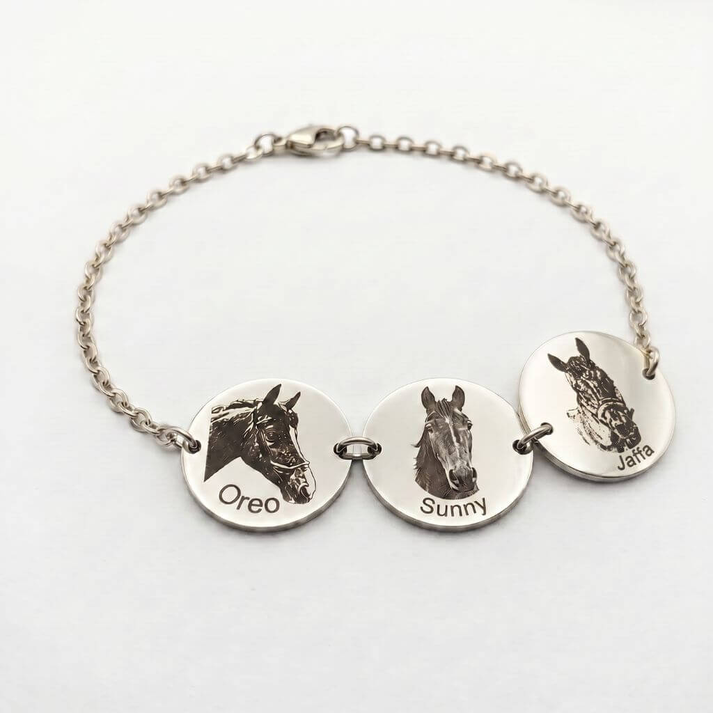 Silver bracelet with engraved horse faces and names on a white background