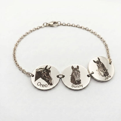 Silver bracelet with engraved horse faces and names on a white background