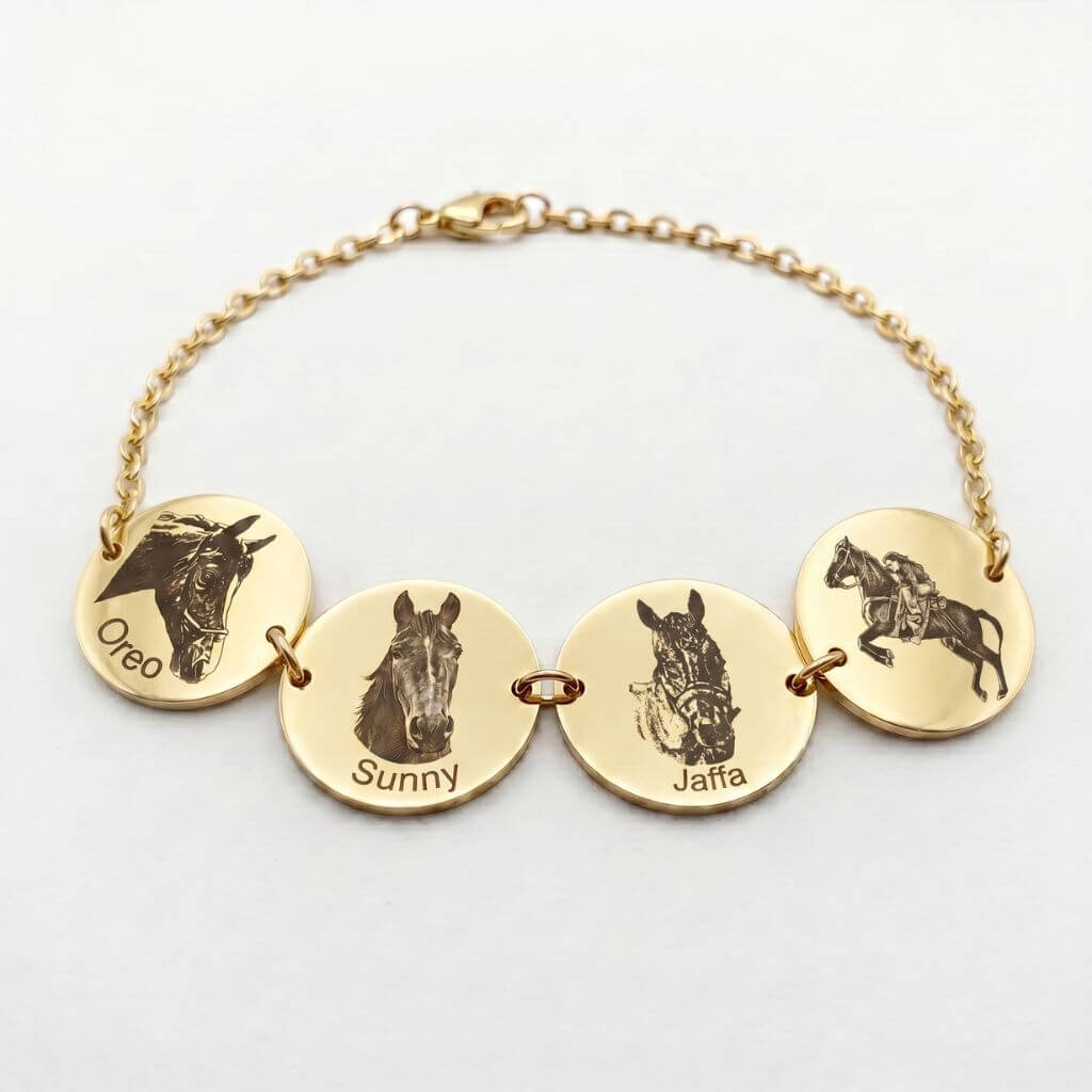 Gold bracelet with engraved horse heads and names on gold discs against a white background