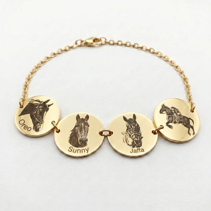 Gold bracelet with engraved horse heads and names on gold discs against a white background