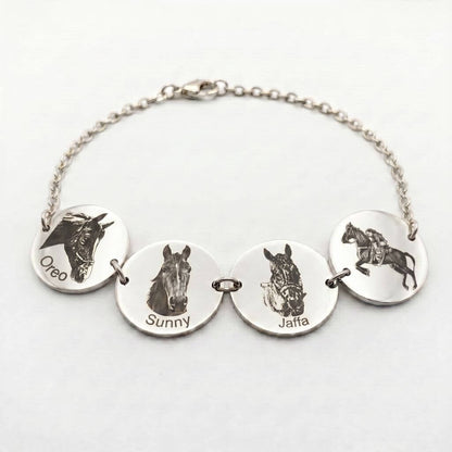 Silver bracelet with engraved horse images and names on round silver discs against a white background