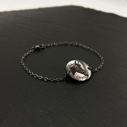 Silver bracelet with a round pendant on a dark surface, BR-P1-ST