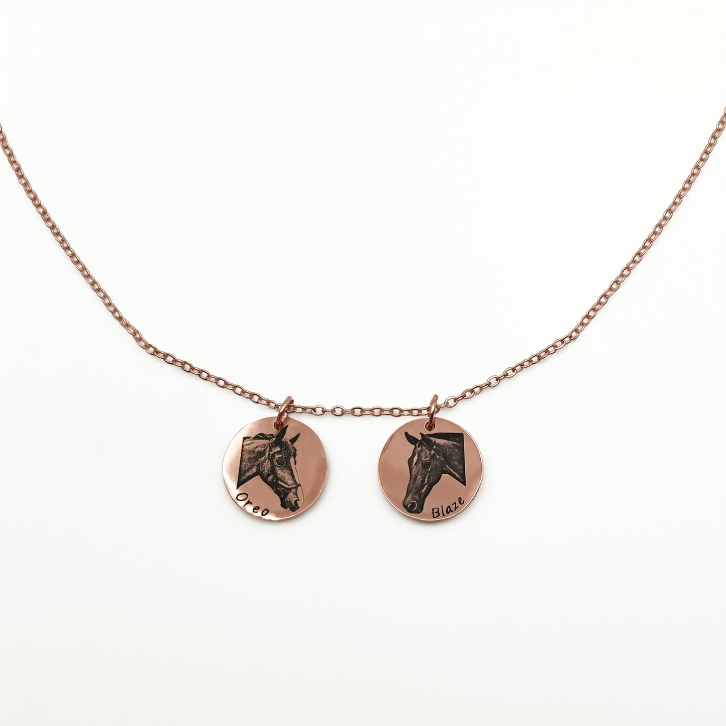 Necklace with two round pendants featuring horse faces on a white background