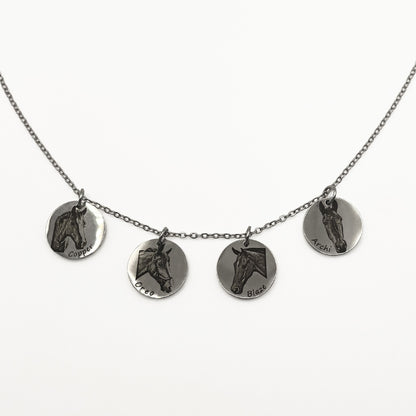 Necklace with four round silver pendants featuring horse faces on a white background